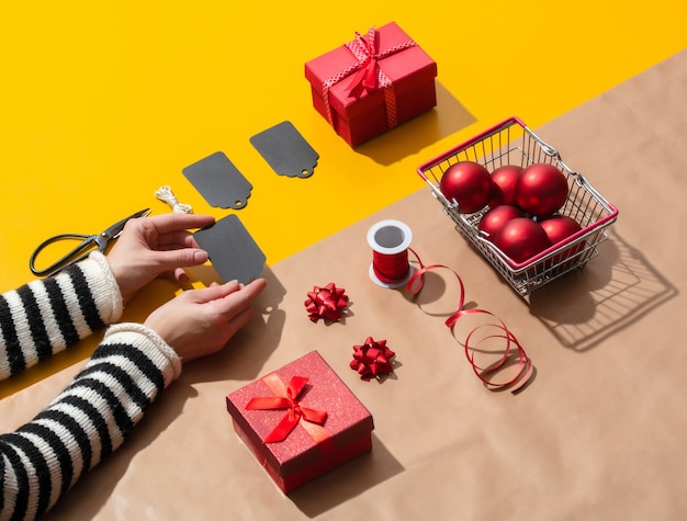 Female hand holds a lable for Christmas gifts