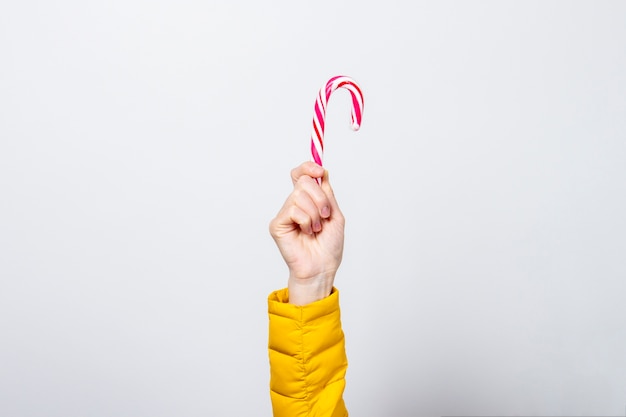 Female hand holds lolipop isolated