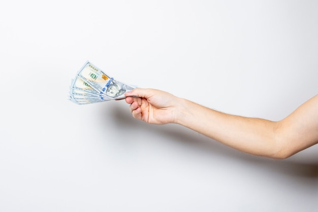 Female hand holds money on a white isolated