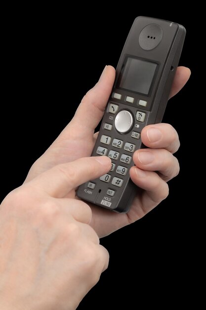 Female hand holds a phone isolated on black background