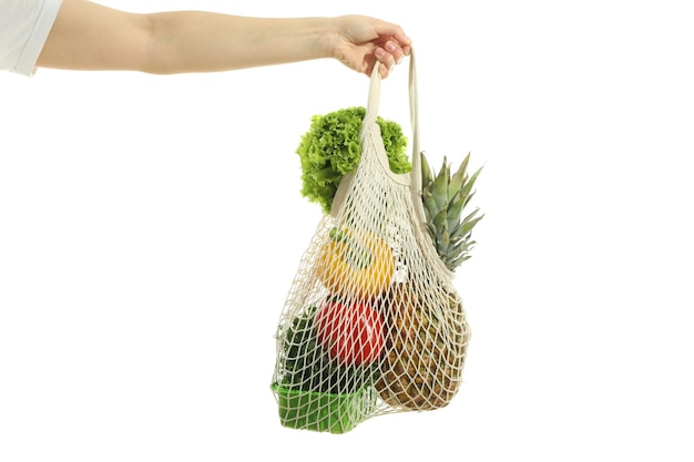 Female hand holds string bag with food isolated on white background