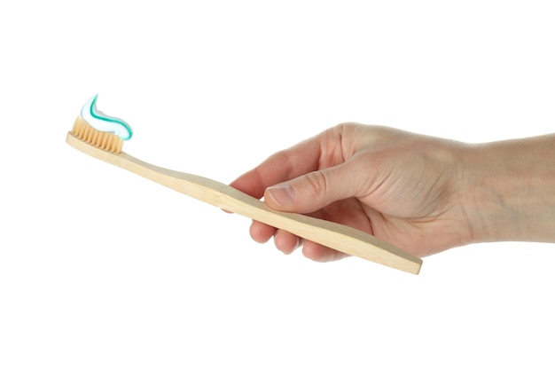 Female hand holds toothbrush with toothpaste isolated on white background