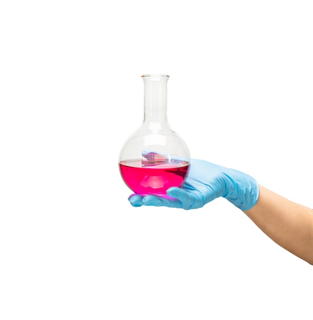 Female hand of a medic in a safe blue rubber glove in which the liquid is a red vaccine, the development of drugs.