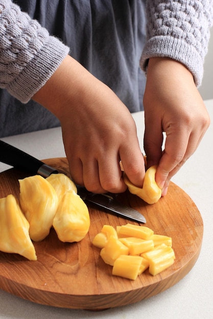 Foto il processo a mano femminile prende i semi di jackfruit