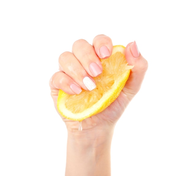 Female hand squeezing lemon isolated on white