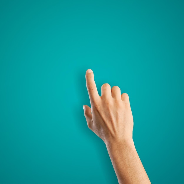 Photo female hand touches finger a blue background. flat lay, top view