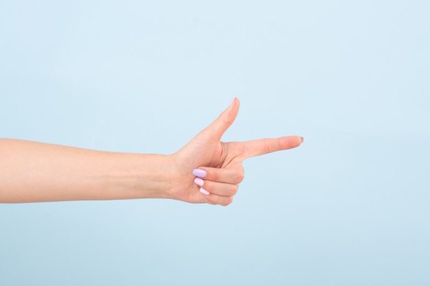 женская рука с ярким маникюром, указывая указательным пальцем