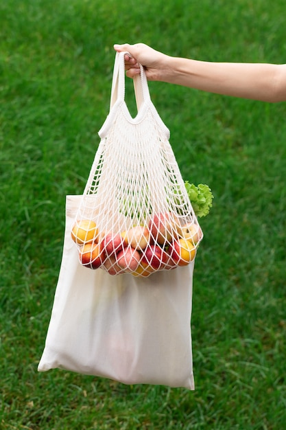 Female hand with cotton eco bag . Zero waste concept