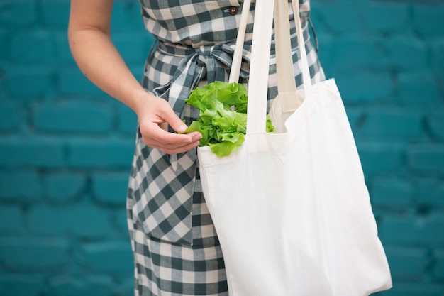 female hand with cotton eco bag.  zero waste concept