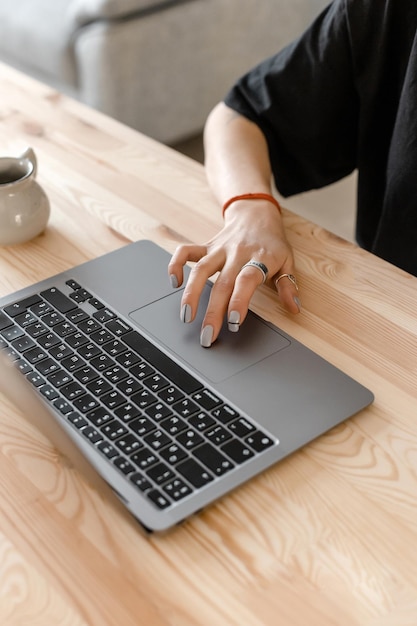 Female hand with manicure and computer