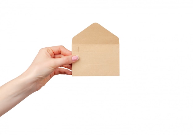 Female hand with manicure holding open beige envelope