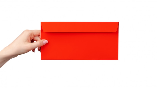 Female hand with manicure holding red envelope