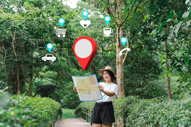 Female hand with map in forest background Happy young woman with a map traveling in nature travel concept Hiking trail navigation app showing resting spots