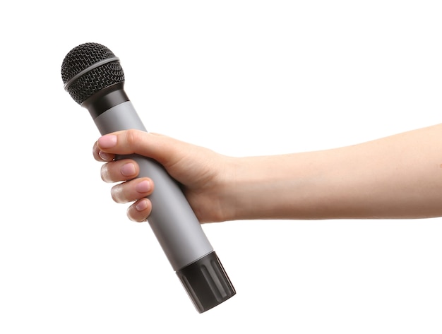 Female hand with microphone on white