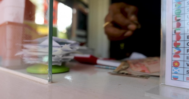 Female hand with money in cash department window