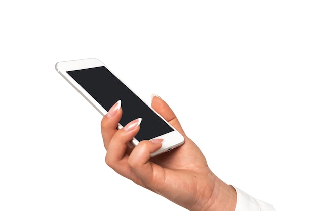 Female hand with perfect fingernails holding smartphone with blank screen on a white background in closeup