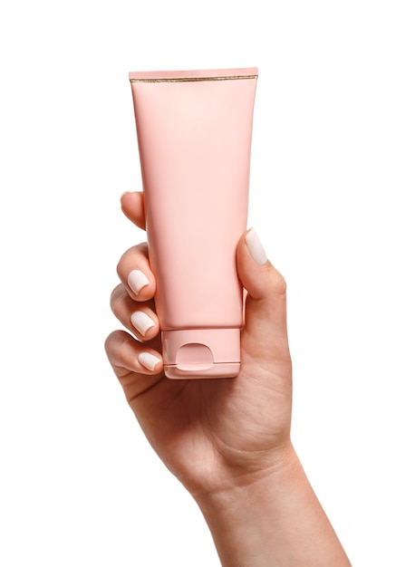 Female hand with a tube of cream, isolated. Layout