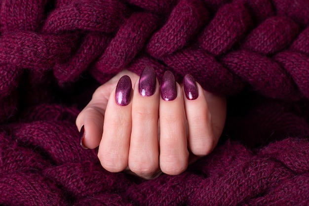Female hand with wine red manicure nails