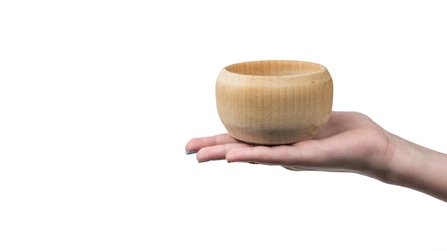 Female hand with wooden bowl isolated on white surface