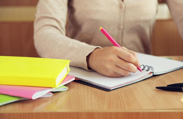 Photo female hand writing in notebook closeup