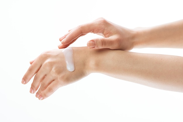 Female hands applying cream moisturizing cosmetics massage