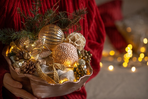 Female hands are holding a set of Christmas decorations. concept of a cozy home and a festive atmosphere.