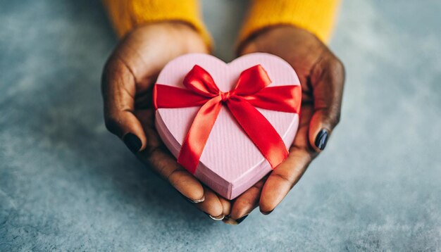 Photo female hands cradle a heartshaped gift embodying love and celebration for occasions like valentine