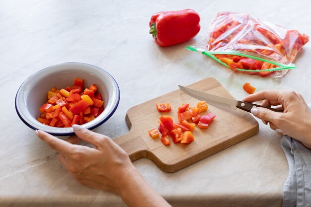 Female hands cutting fresh bell peppers