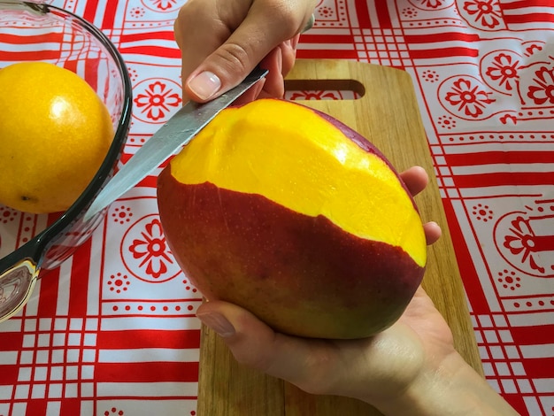 Female hands cutting manga in small slices