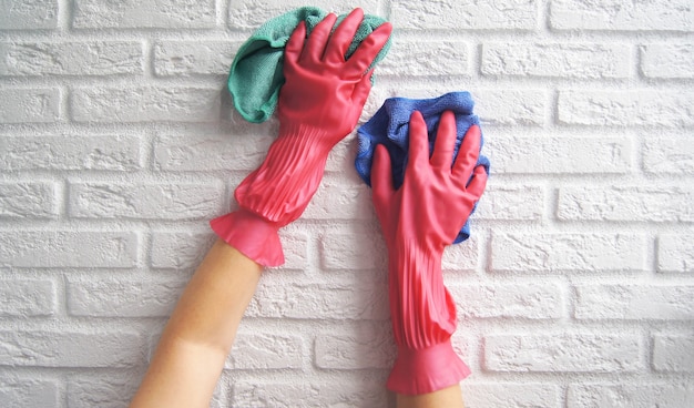 Female hands disinfect or wash of white break wall