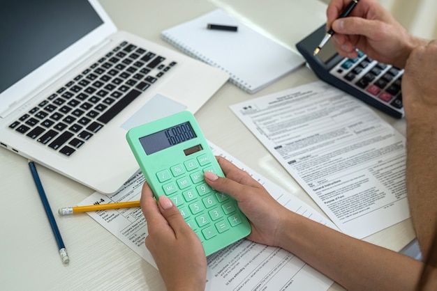 Female hands filling up 1040 individual tax form close up