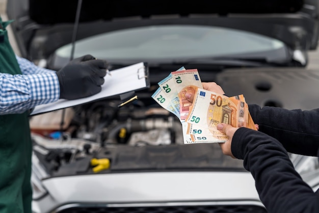 Female hands giving euro banknotes for car service