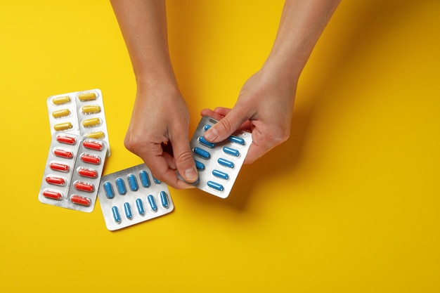 Female hands hold blister pack with pills isolated