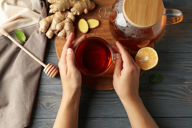 Female hands hold cup of ginger tea