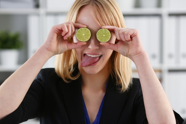 Female hands hold a cut fruit at eye level