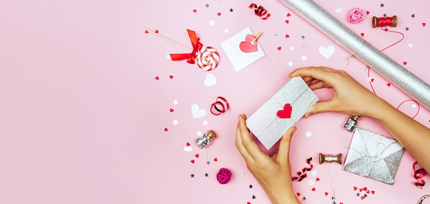 Female hands hold a love letter in an envelope