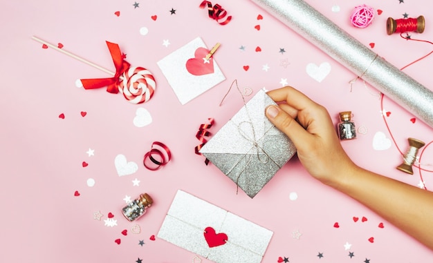 Female hands hold a love letter in an envelope