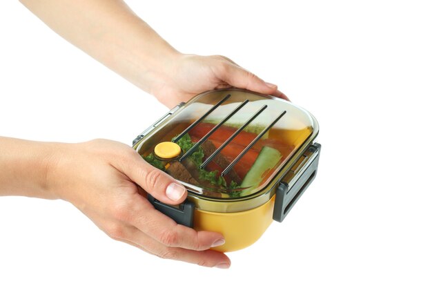 Female hands hold lunch box, isolated on white background