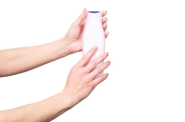 Female hands hold shampoo bottle with copy space