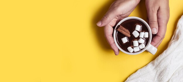 Female hands hold a thick hot chocolate cup