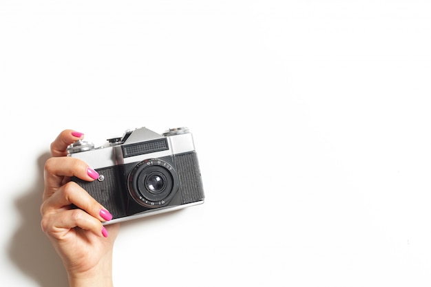 Female hands hold vintage camera 