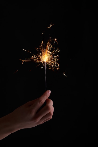 Female hands holding bengal light.