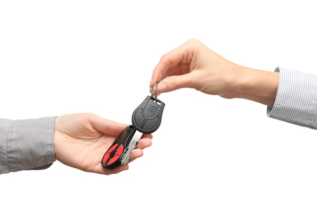 Female hands holding car keys on white background Buying car concept