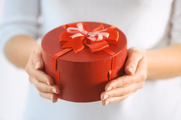 Female hands holding gift box, closeup