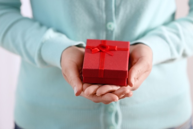 Female hands holding gift box, closeup