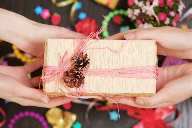 Female hands holding gift close-up