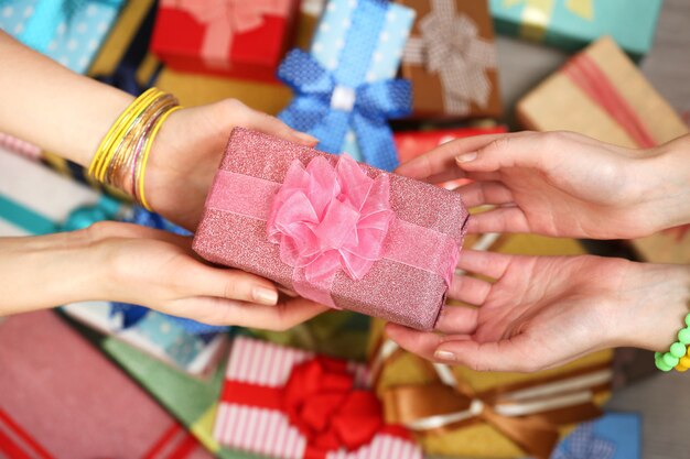 Female hands holding gift close-up