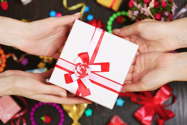 Female hands holding gift close-up