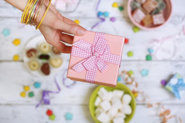 Mani femminili che tengono il primo piano del regalo