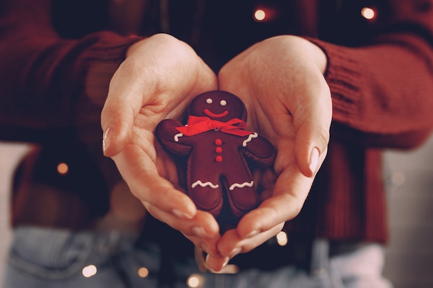 Female hands holding gingerbread man